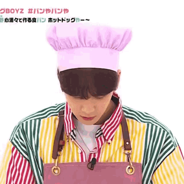 a man wearing a pink chef hat and an apron has the word boyz on the bottom right
