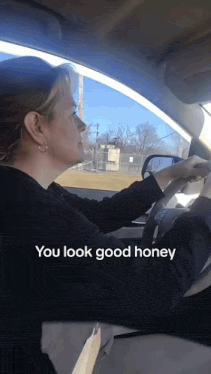 a woman driving a car with the words " you look good honey " on the bottom