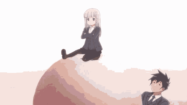 a man and a girl are sitting on a large ball