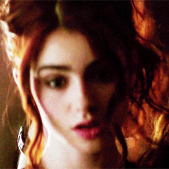 a close up of a woman with red hair