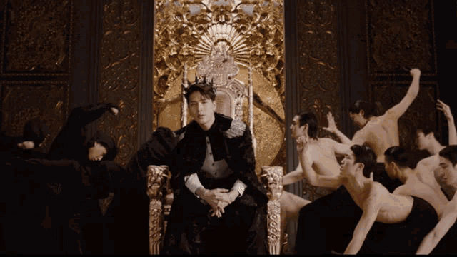 a man in a crown sits on a throne surrounded by men
