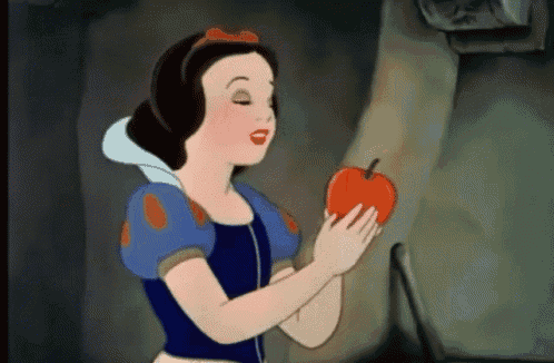 snow white is holding a red apple in her hands