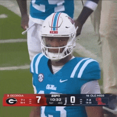 a football player wearing a helmet that says reess stands on the field