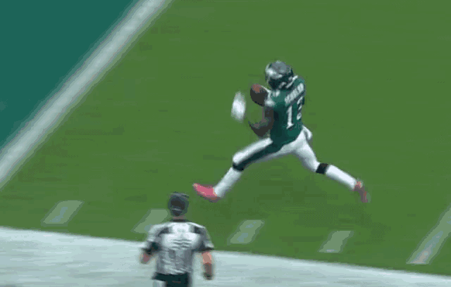 a football player in a green uniform with the number 8 on it