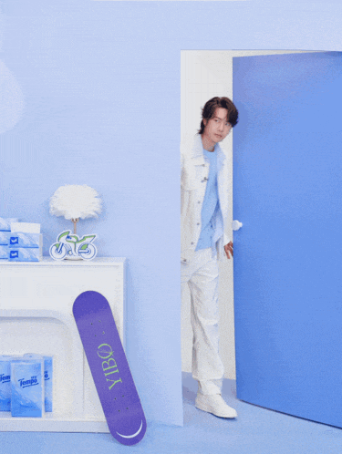 a person standing next to a skateboard that says vibo