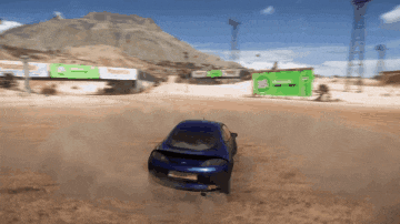 a blue car is driving down a dirt road in front of a green bp sign