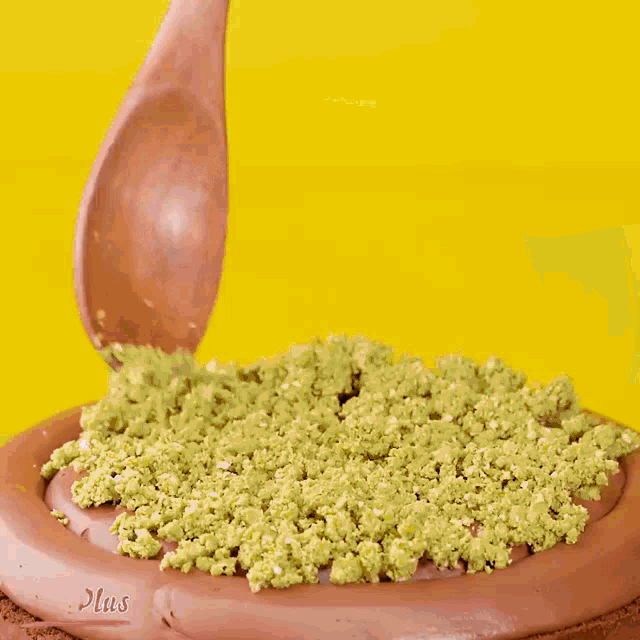 a person is making a chocolate cake with pistachios on top of it