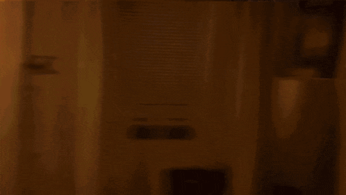 a blurry photo of a person standing in a dark room