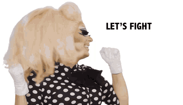 a drag queen says let 's fight while wearing a black and white polka dot dress