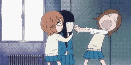 a group of girls are standing next to each other in a room and fighting .