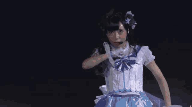 a woman in a white and blue costume with a microphone on her head