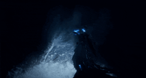 a person in a dark room with a blue light coming out of their eyes