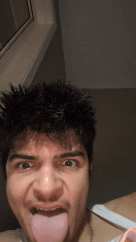 a man is sticking his tongue out and making a face