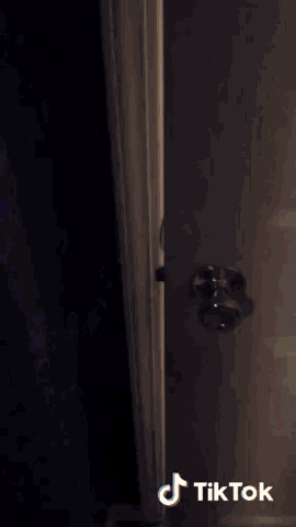a tiktok video of a white door with a black background