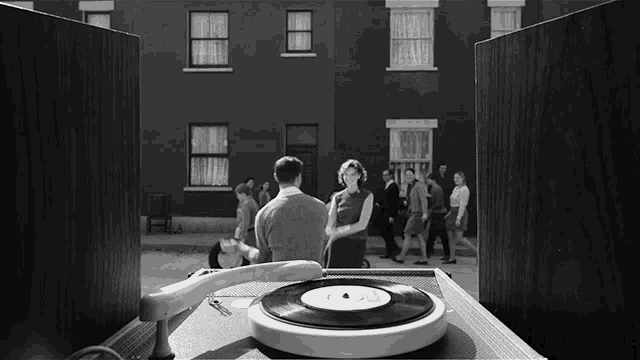 a black and white photo of a man and woman dancing