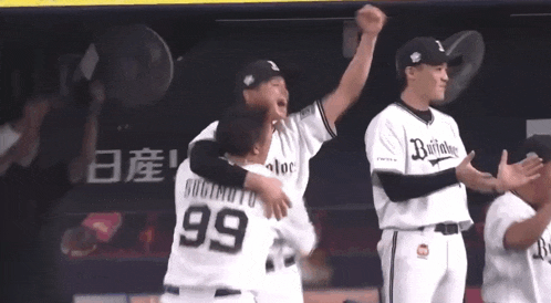 a baseball player with the number 99 on his back is hugging another player