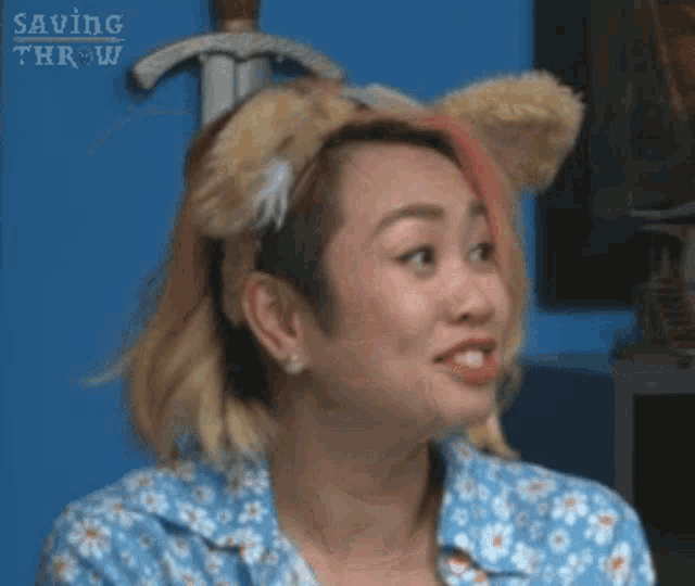 a woman wearing a headband with cat ears and a sword .