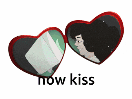 a heart shaped mirror with the words now kiss written below it