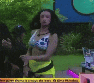 a woman in a bikini is dancing in front of a screen that says elma phinehas winning