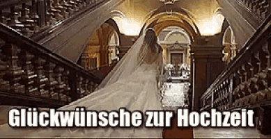 a bride in a wedding dress is walking down a set of stairs