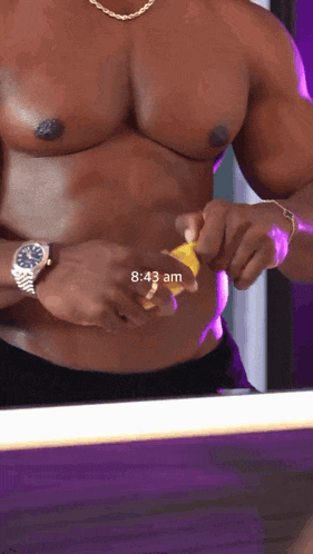 a shirtless man is taking a picture of himself in front of a mirror with the time of 8:43 am