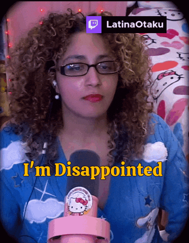 a woman wearing glasses and a hello kitty shirt is disappointed