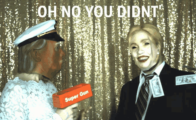 a man holding a super gun talking to another man in a suit