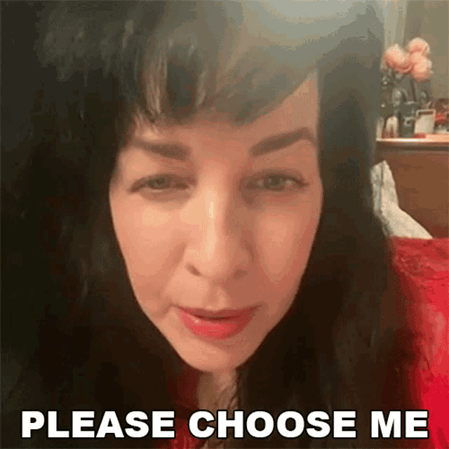 a woman says please choose me in front of flowers
