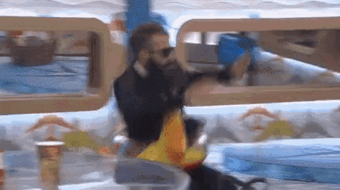 a blurry picture of a man with a beard holding a bag