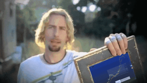 a man holding a picture frame with a graph on it that says ' usd ' on it