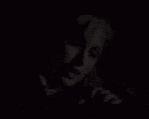 a close up of a person 's face in the dark
