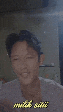 a picture of a young man with the words milik siti written below him