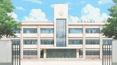 a large white school building with a clock on top of it
