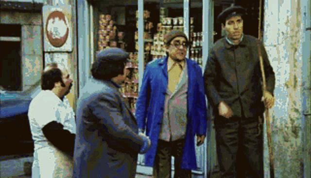 three men are shaking hands in front of a store with a sign that says ' a ' on it