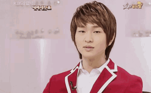 a young man in a red jacket with a yellow tag that says ' aoi ' on it
