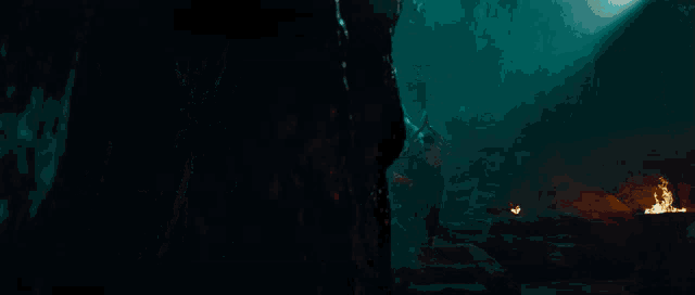 a dark room with a statue of a man with horns