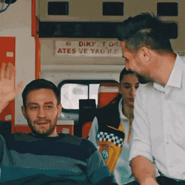 a man in an ambulance with a sign that says diki tok ates ve yag il
