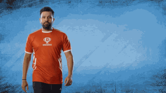 a man in a red shirt that says dream11