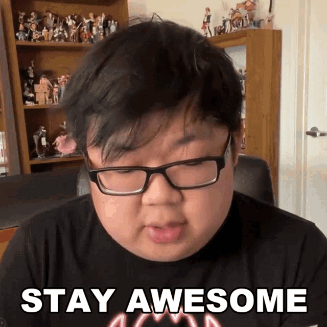 a man wearing glasses and a shirt that says stay awesome on it