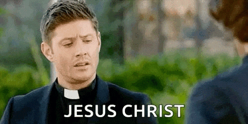 a priest is talking to another priest while wearing a clergy robe .