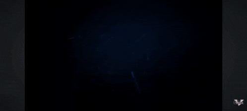 a dark room with a light shining through the ceiling and a few letters that say ' htc ' on it