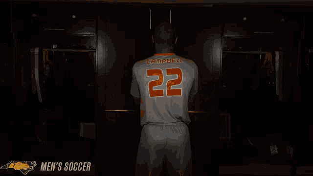 a man in an orange and grey striped shirt with the number 22 on it