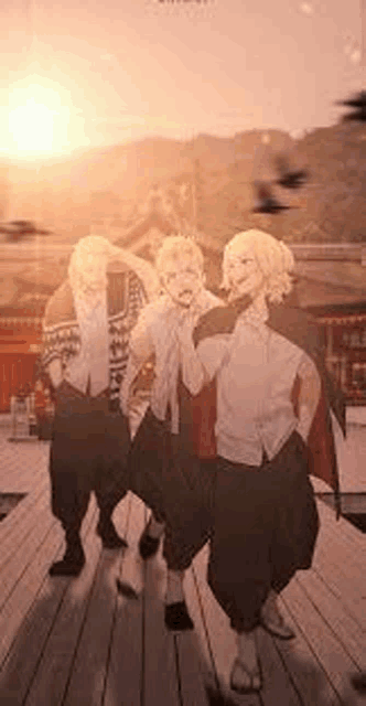 a group of people are standing next to each other on a wooden deck at sunset .