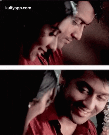 a man and a woman are looking at each other and smiling . the man is wearing a red shirt .