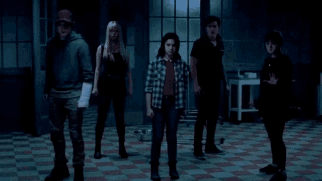 a group of people are standing next to each other in a room .