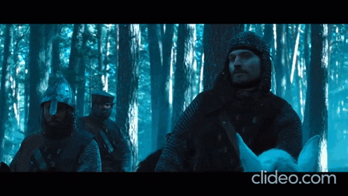 a man riding a white horse in a forest with the website clideo.com in the lower right corner