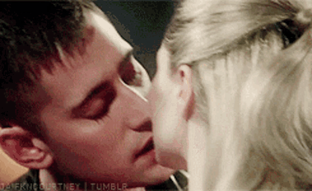 a close up of a man and a woman kissing with a tumblr logo in the bottom right