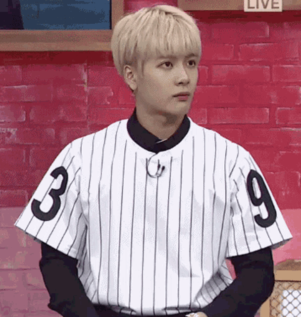 a young man wearing a baseball uniform with the number 3 and 9 on the sleeves