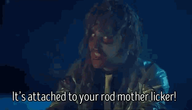 a close up of a person 's face with the words `` it 's attached to your rod mother licker ''