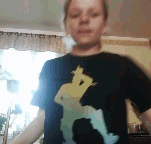a person wearing a black t-shirt with a picture of a person on it